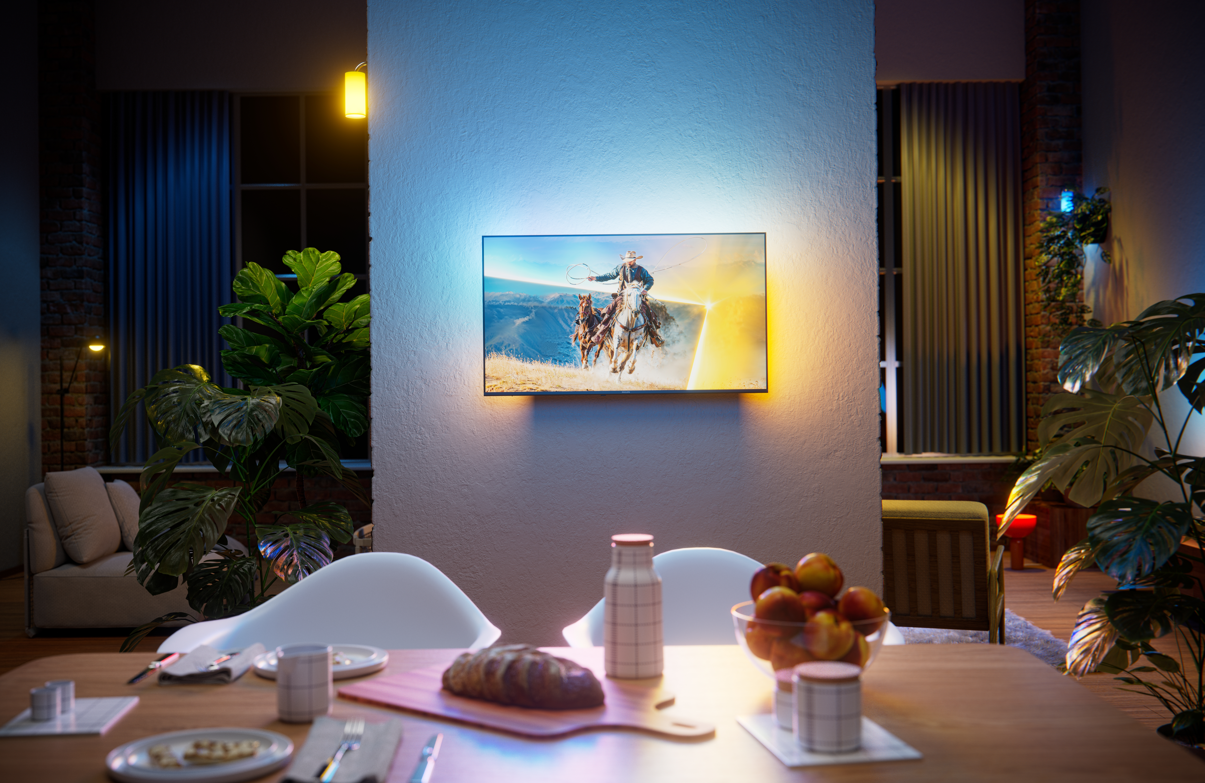 Philips Ambilight TV mounted on a wall in a modern dining and living space, displaying a horseback riding scene with warm and cool ambient lighting extending onto the wall behind the screen.