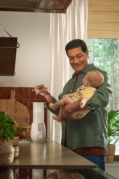 Parent using Premium 2-in-1 Warmer & Sterilizer