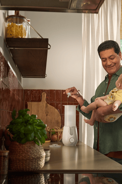 Parent using Premium 2-in-1 Warmer & Sterilizer