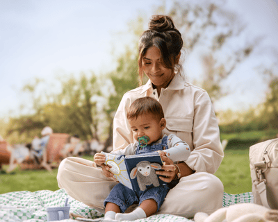 Mom is reading a book to her toddler