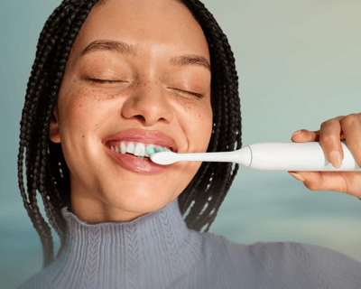 A patient brushing with the power toothbrush.