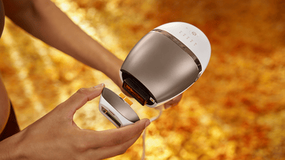 A close-up product image of a grey Philips Lumea Sunstone 8000 being held up to the camera.