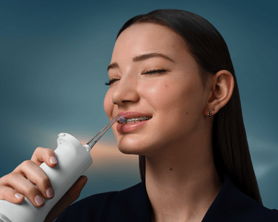 Philips power flosser in use of someone with wearing braces