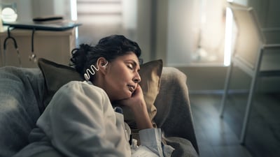 Woman wearing Philips Sleep Headphones comfortably while sleeping on her side