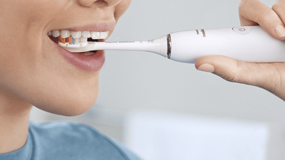 Patient brushing back teeth.