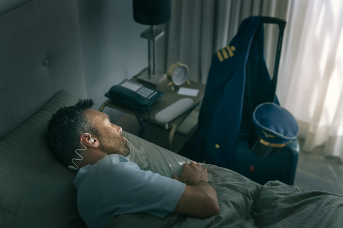 Image showing Philips Sleep Headphones that fit around a man’s head tightly, but comfortably.