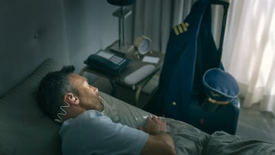 Image showing Philips Sleep Headphones that fit around a man’s head tightly, but comfortably.