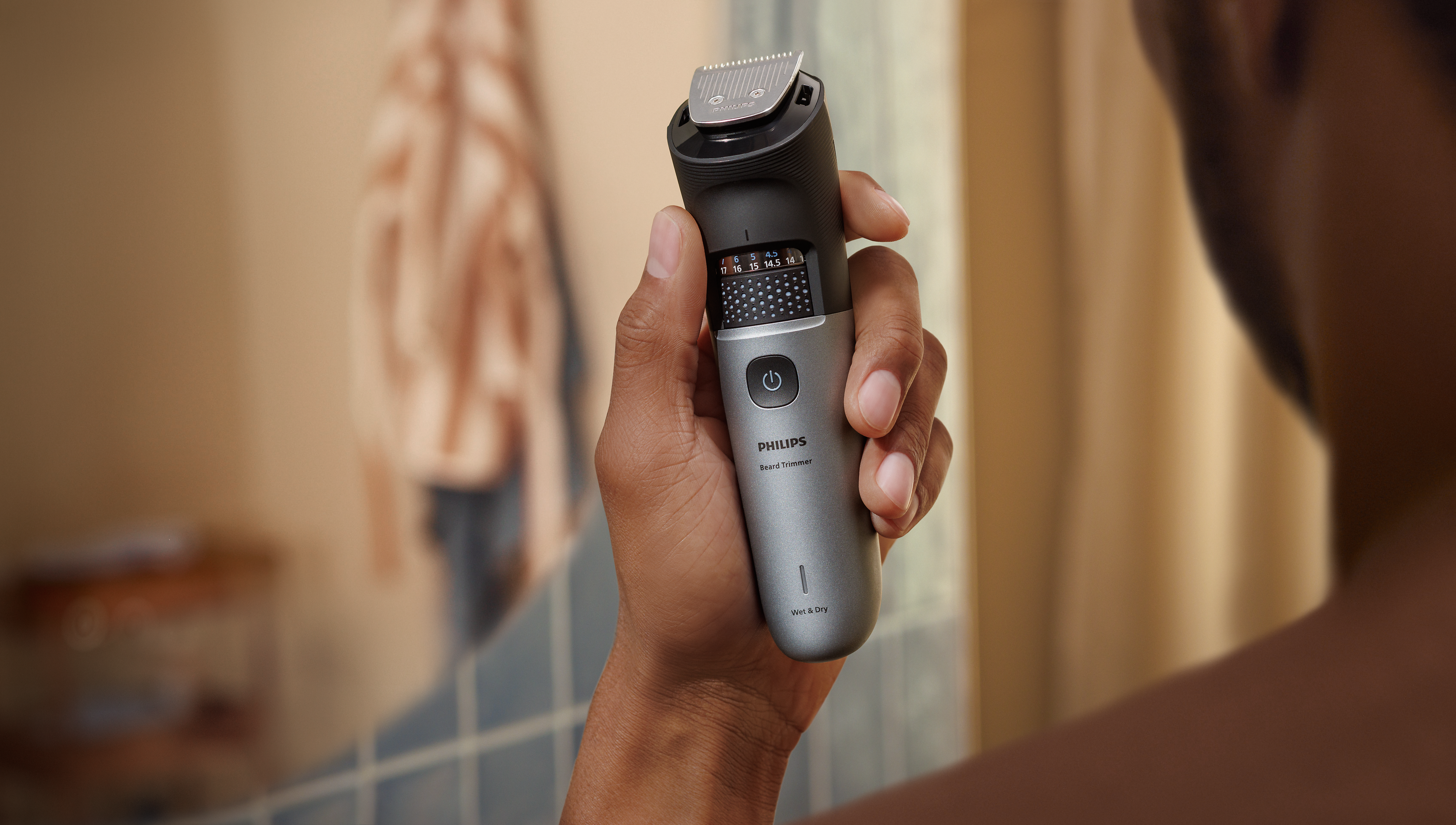 Man holds waterproof Beard Trimmer 7000 in shower