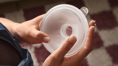 A woman holds her Philips Avent Wearable Breast Pump's silicone shield.