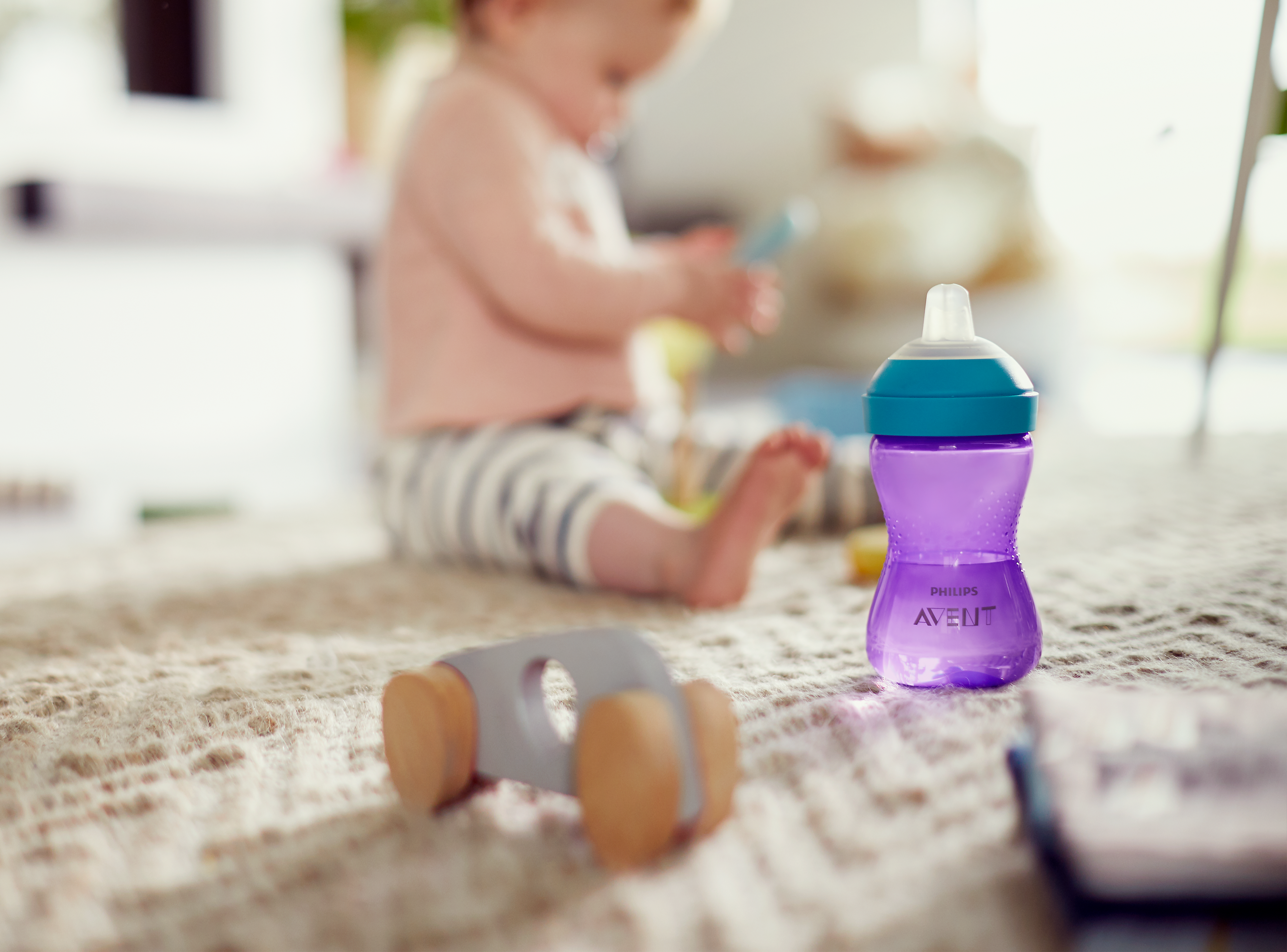 Bebê segurando um copo para crianças