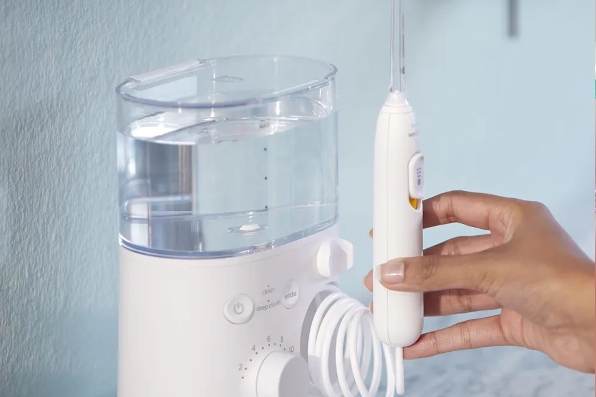 Image of hand using countertop power flosser