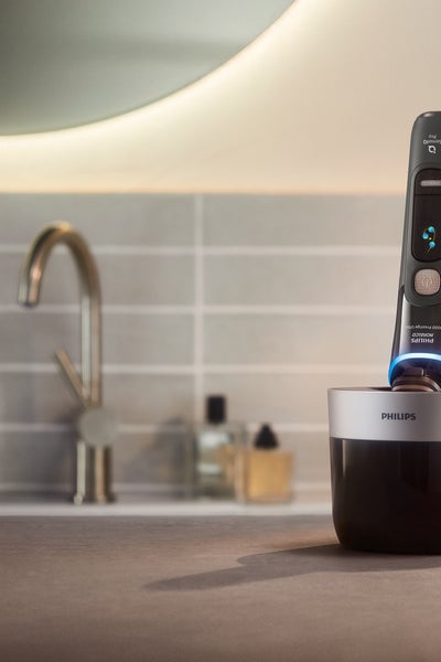 A hand holding an electric shaver