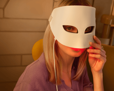 Person wearing the Philips LED Face Mask with built-in eye protection during light therapy