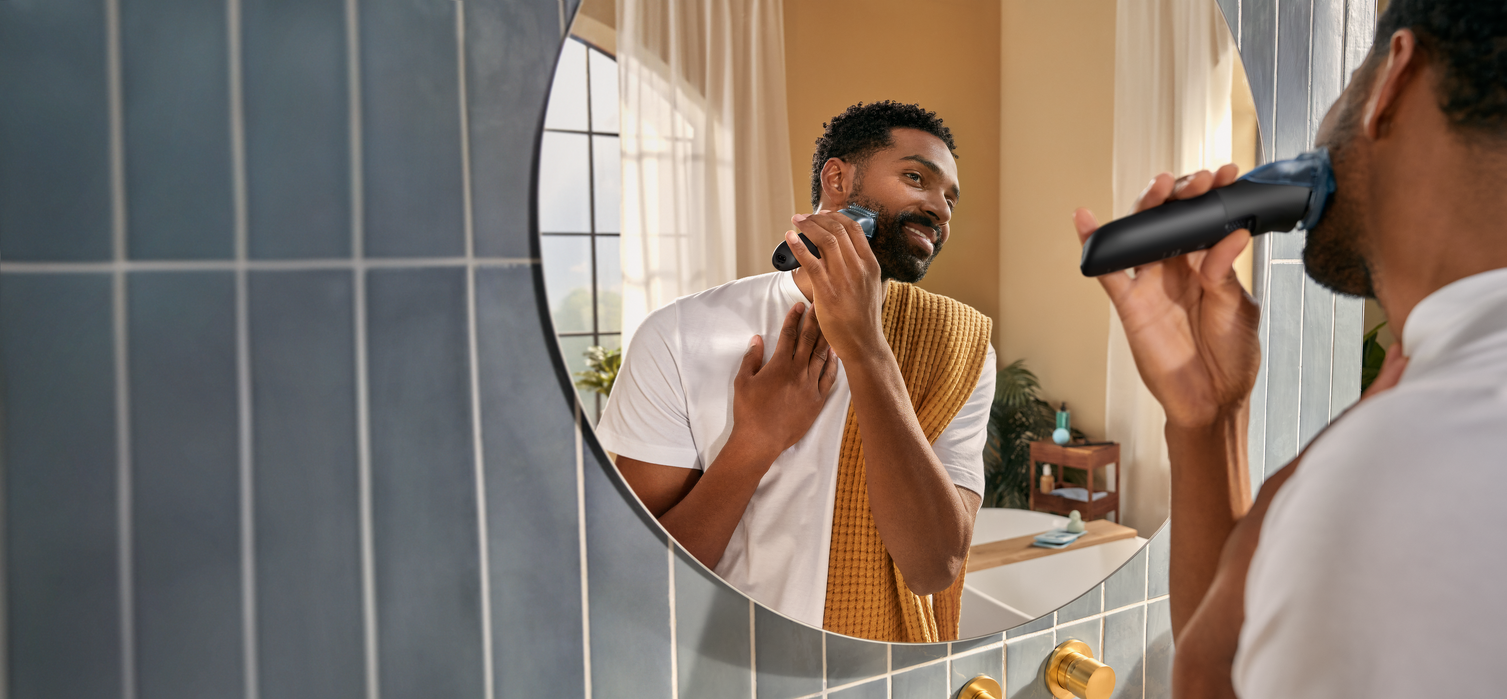 Man shaving his beard in the mirror