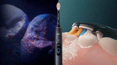 A composited image of bacteria and a sonicare toothbrush in action, seperated by a Philips Sonicare 9900