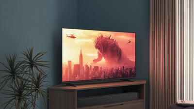 Een Philips-tv op een hoekstandaard toont een Godzilla-film
