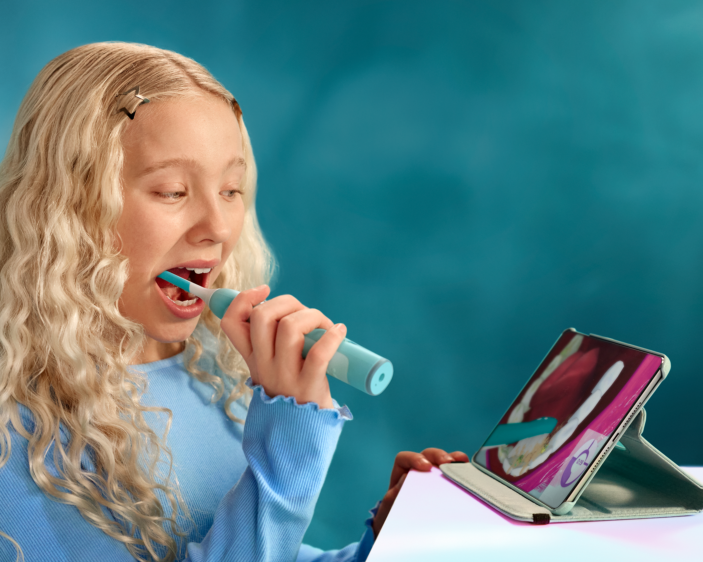 Meisje dat tijdens het poetsen met Sonicare For Kids naar de app kijkt.