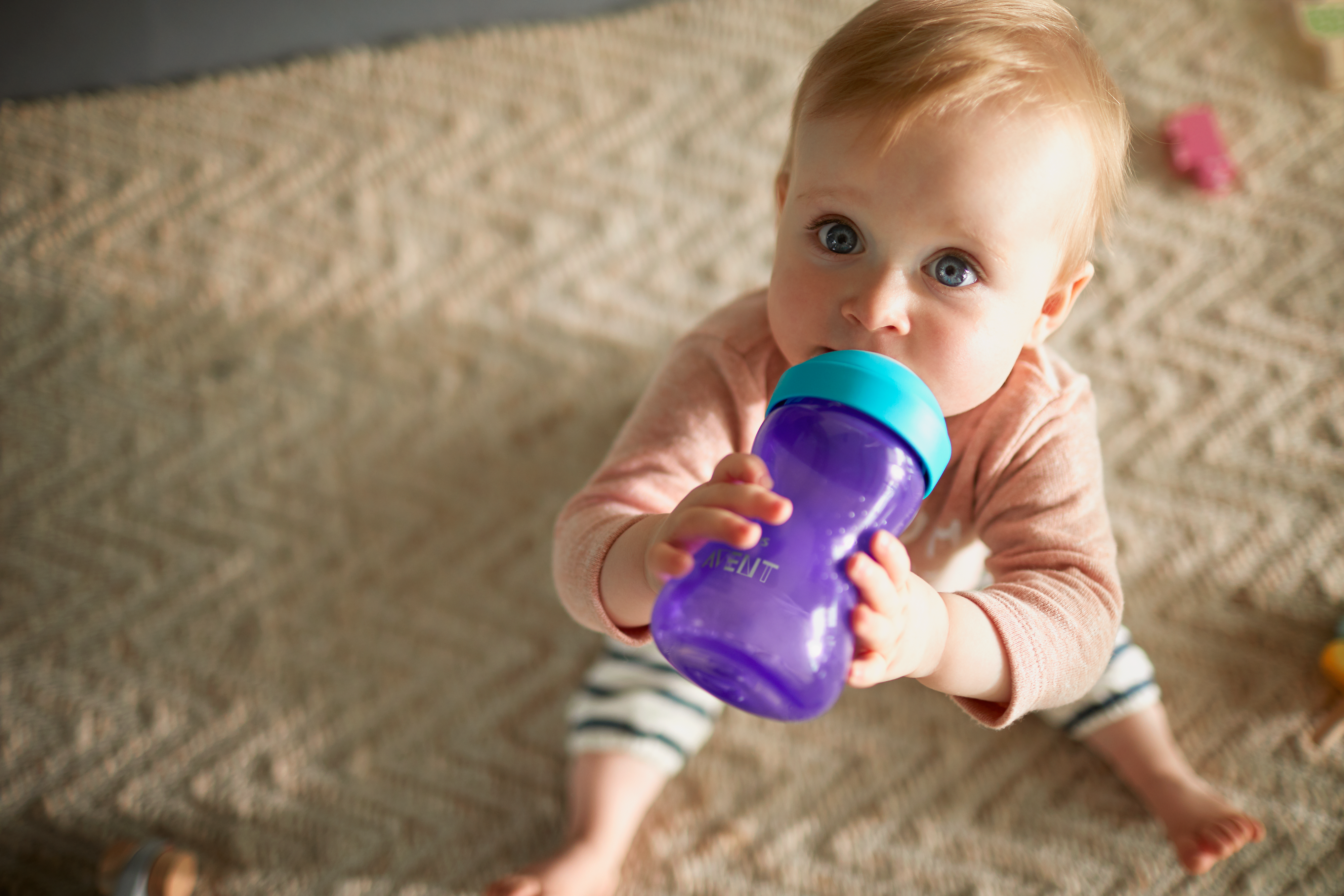 Baby holding a sippy cup