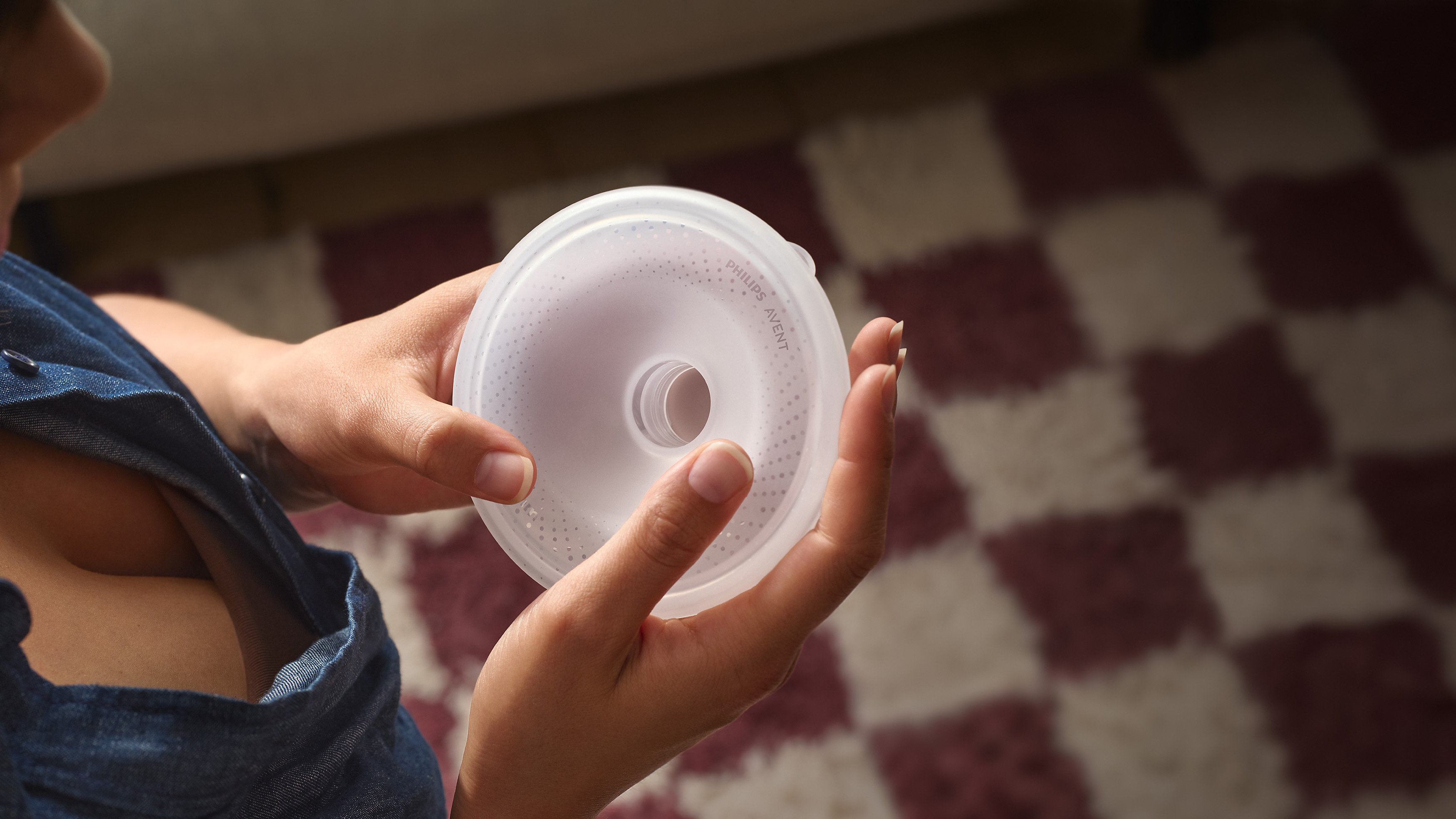 A baby in the bath with two women