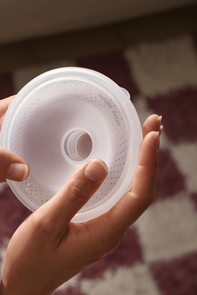 A baby in the bath with two women