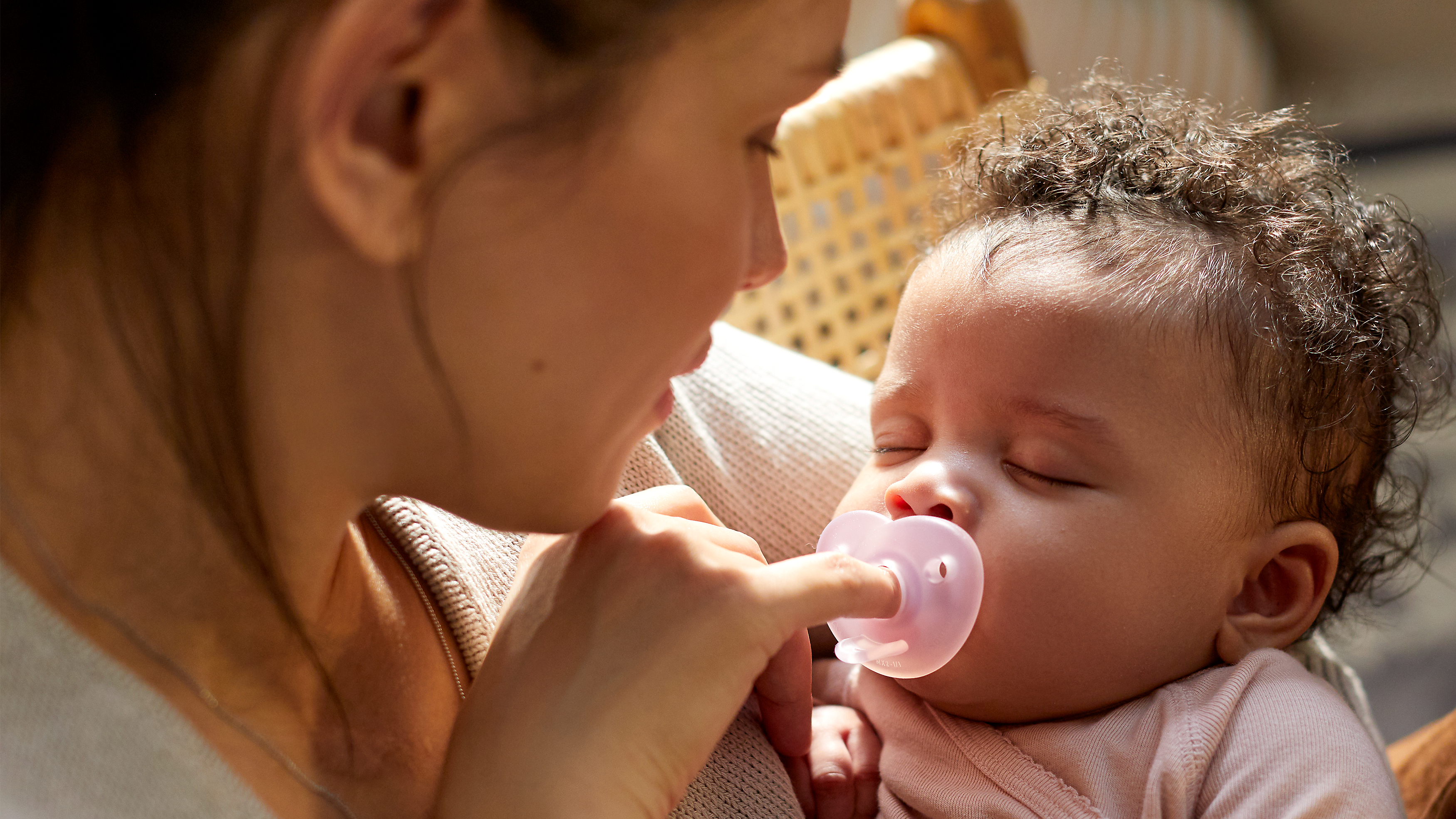 Baby smiling while holding a snuggle