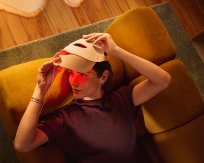 Person using Philips LED Face Mask in Age Care mode with red light therapy