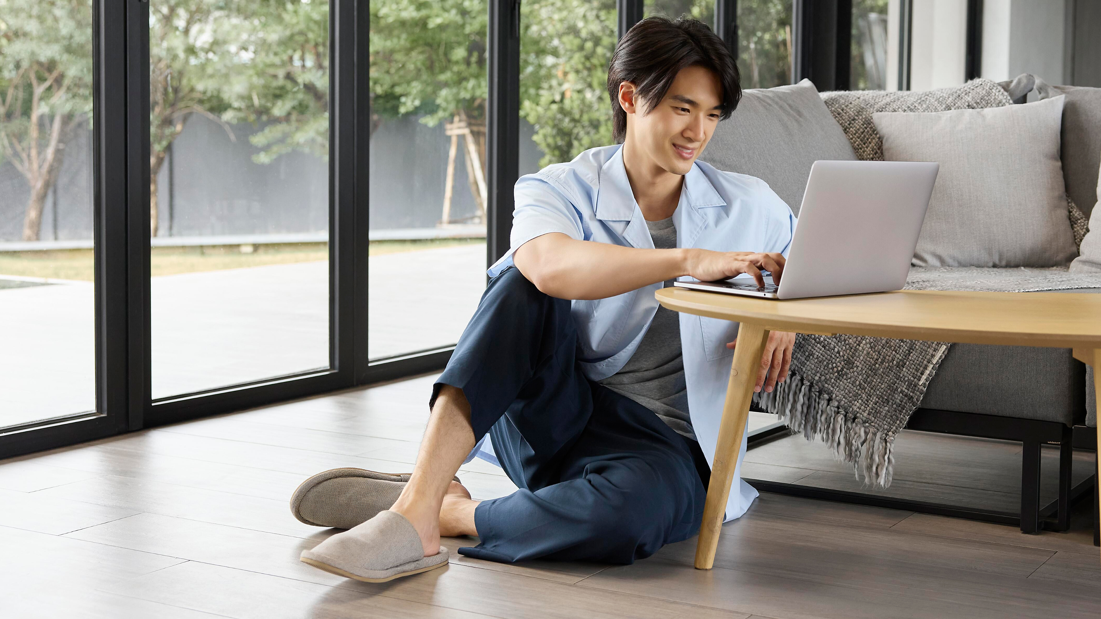 Clean shaven man working from home on a laptop