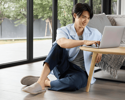 Clean shaven man working from home on a laptop