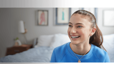 A happy patient with braces smiling.