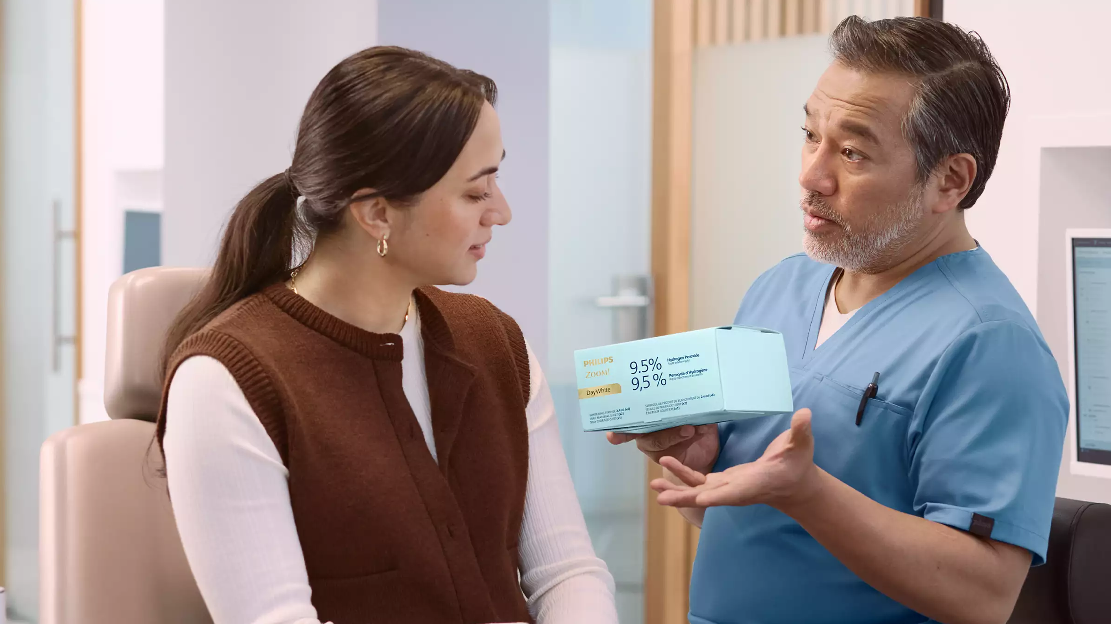 Woman placing a Phlips Zoom! take-home whitening tray