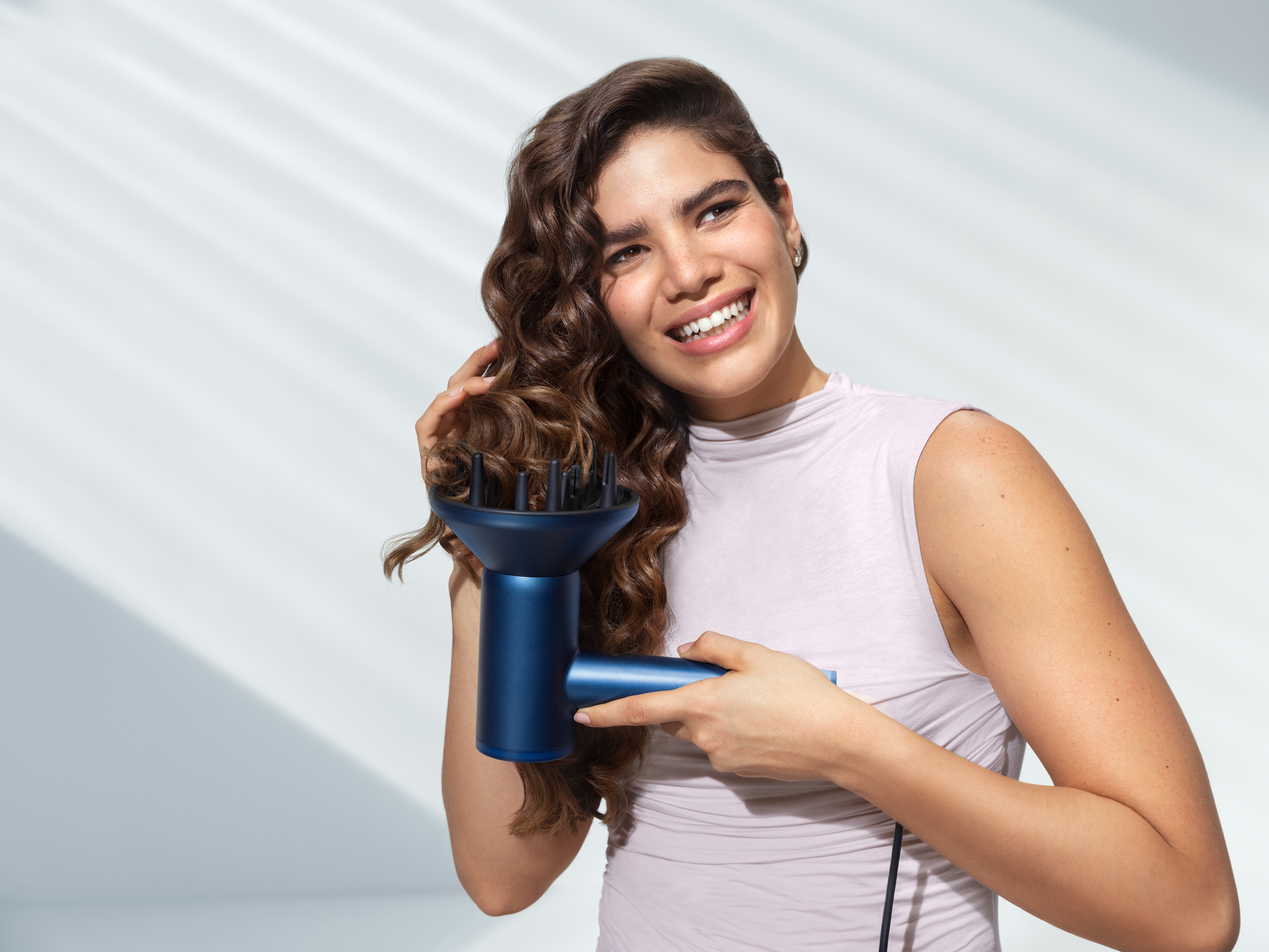 Woman hair drying with hair dryer suitable for different hair types