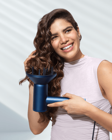 Woman styling hair with Philips lightweight hair dryer