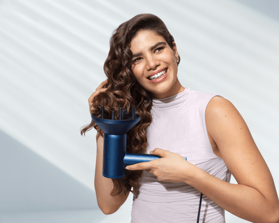 Woman hair drying with hair dryer suitable for different hair types