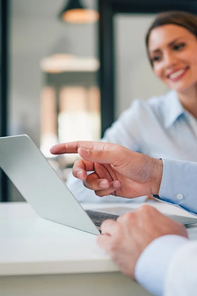 Image of hand pointing to laptop.