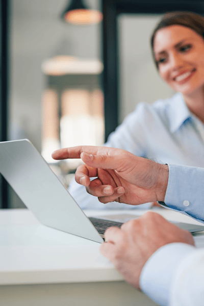 Image of hand pointing to laptop.