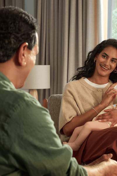 Mom feeding baby with warm sterilized bottle