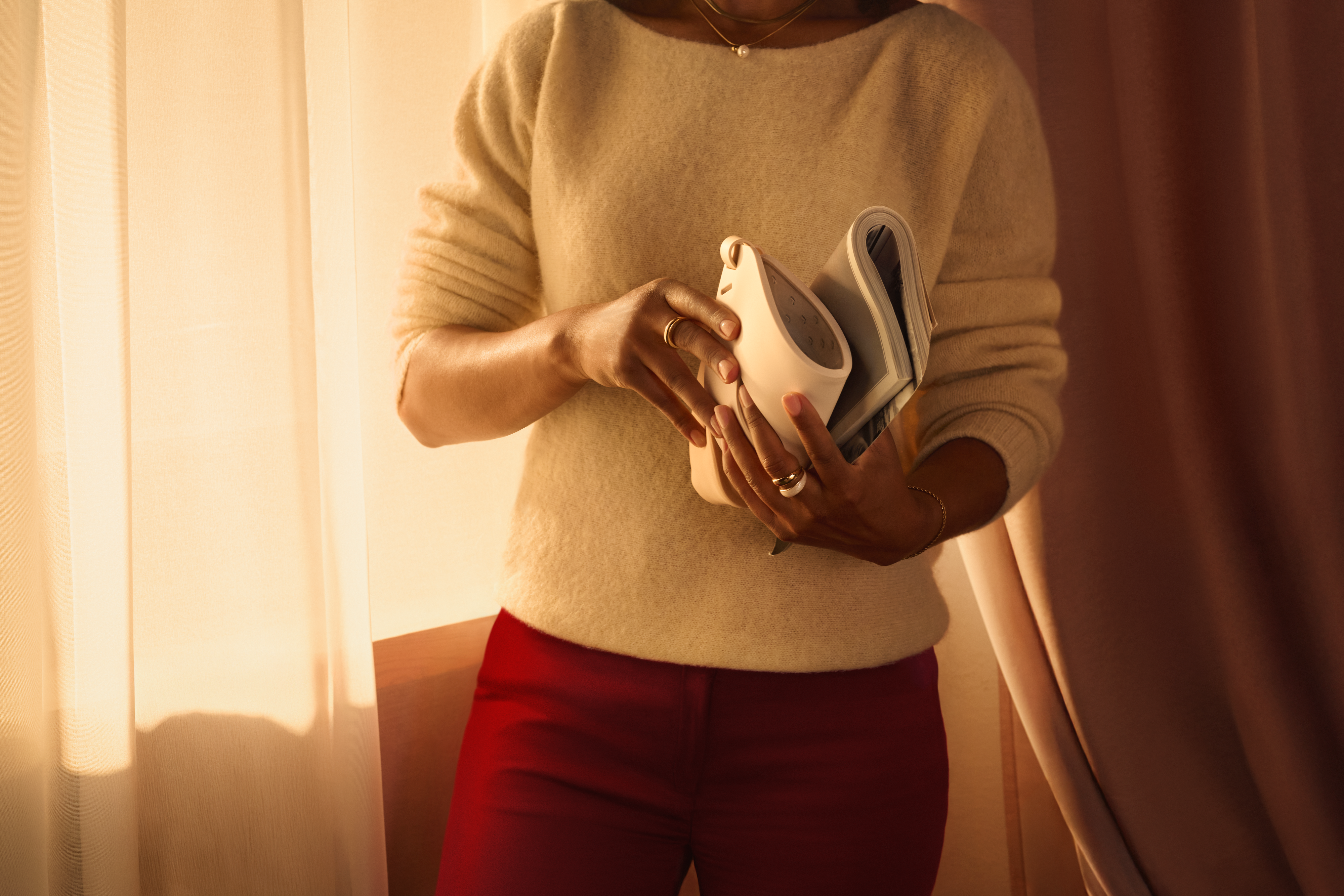 Person holding the Philips LED Face Mask showcasing its lightweight and flexible design