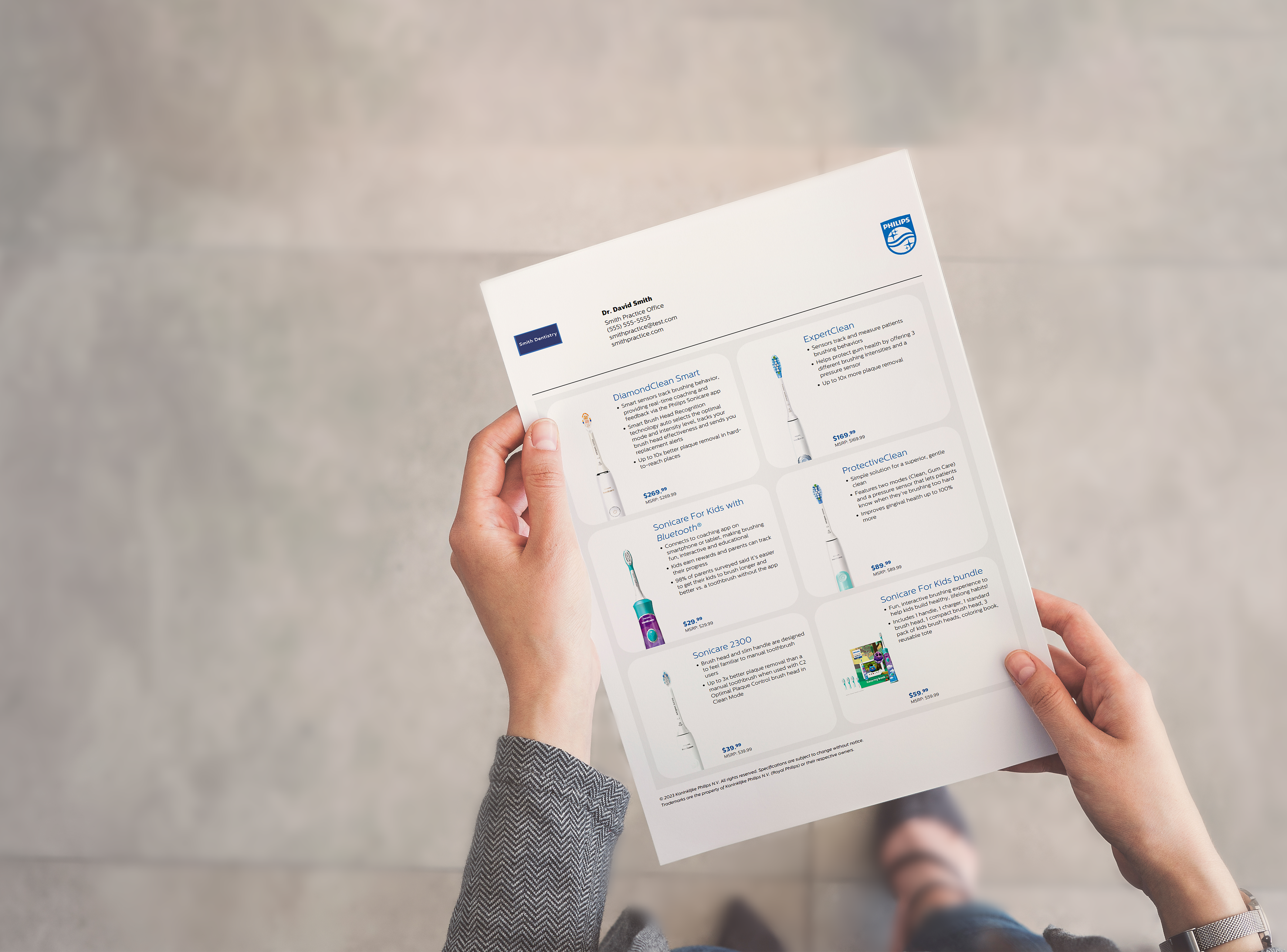 A dental professional holding a customized product sheet.
