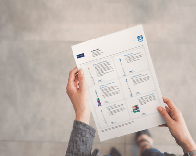 A dental professional holding a customized product sheet.