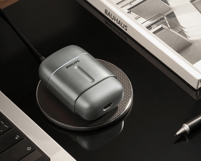 Compact Philips 700 shaver on Wireless Qi-charging compatible pad