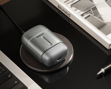 Compact Philips 700 shaver on Wireless Qi-charging compatible pad