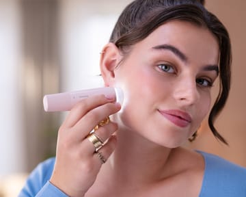 Woman shaving her face