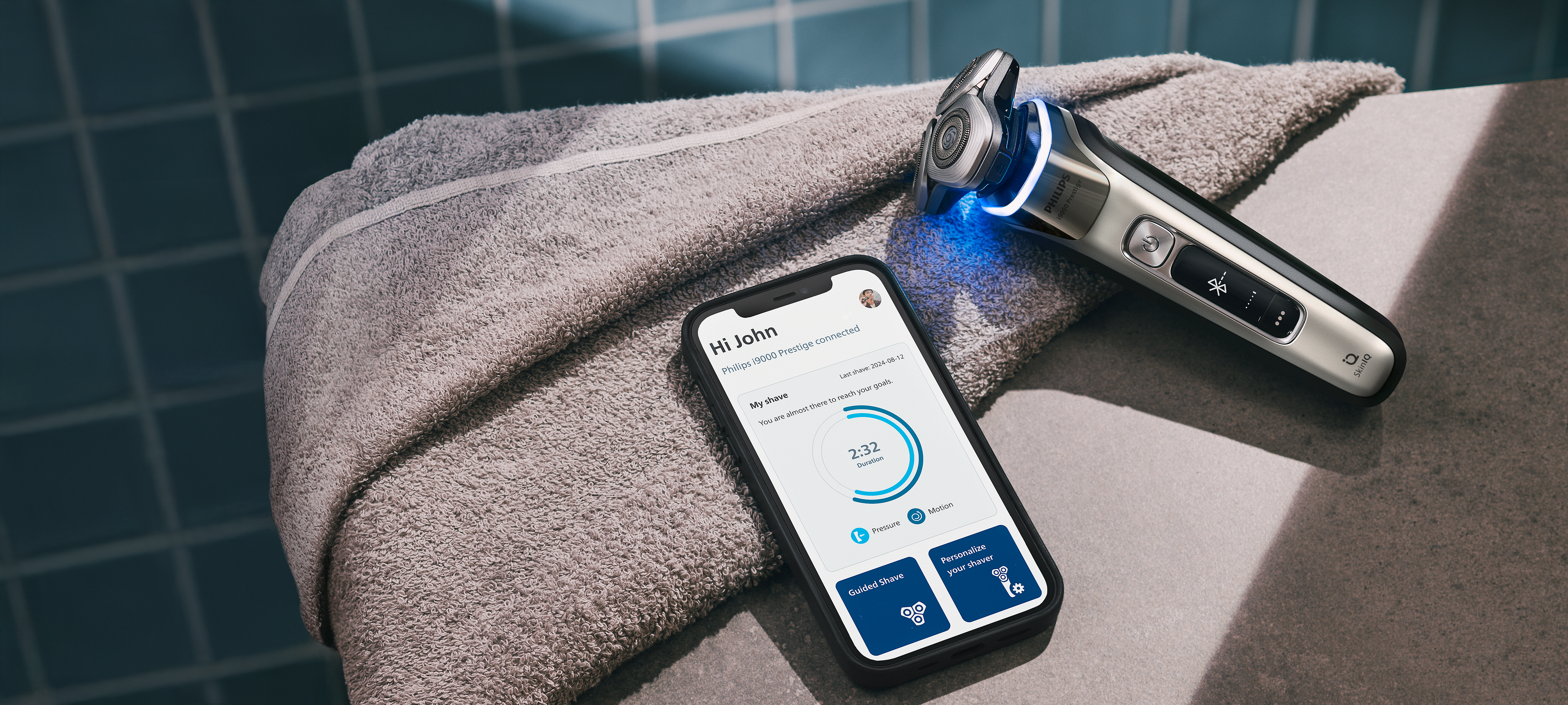 A razor and next to it a display of the Male Grooming App, lying on the table