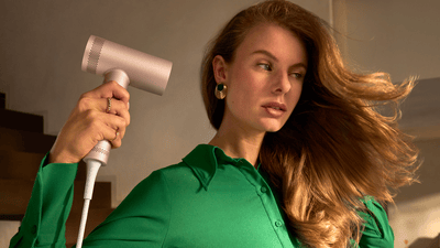 Una mujer se peina con un secador Philips