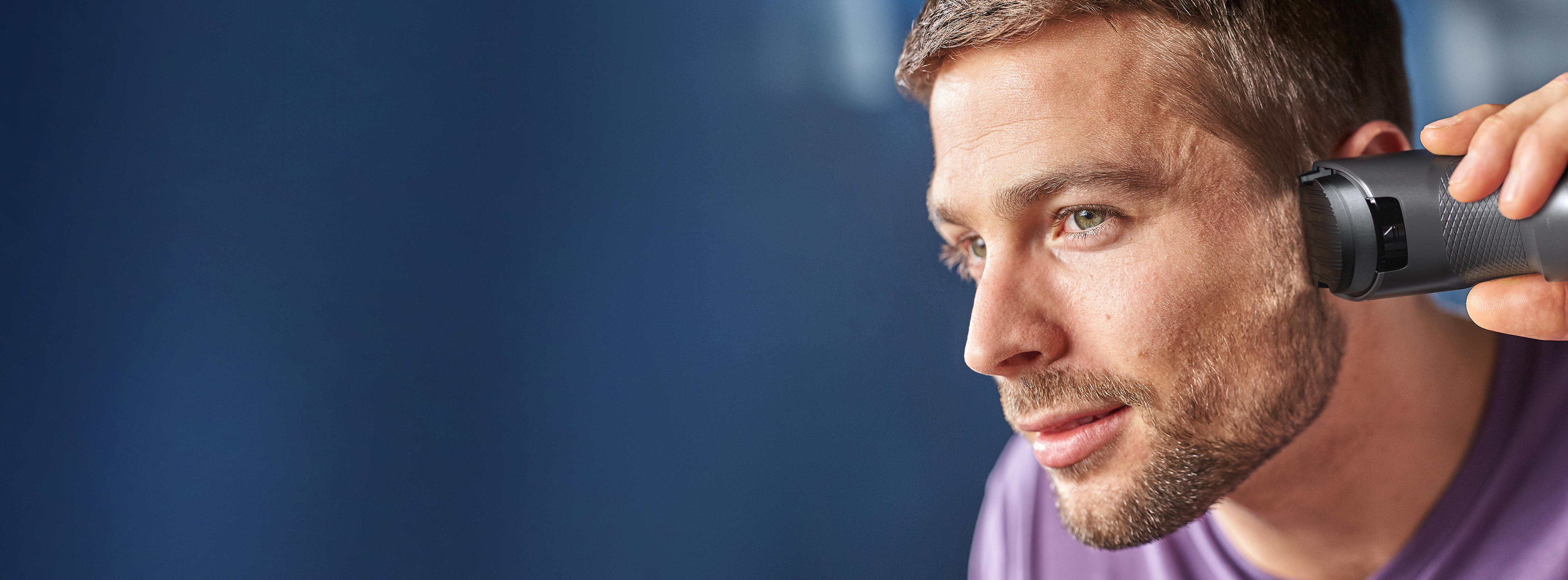 Man trimming his hair with the hair clipper