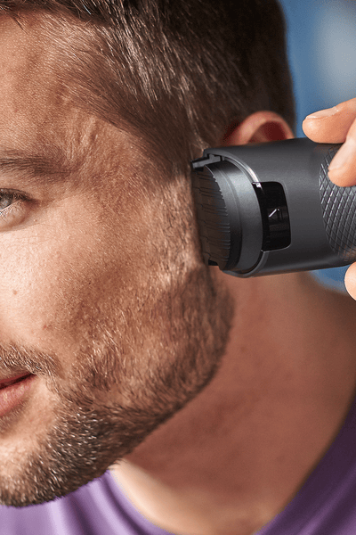 Man trimming his hair with the hair clipper