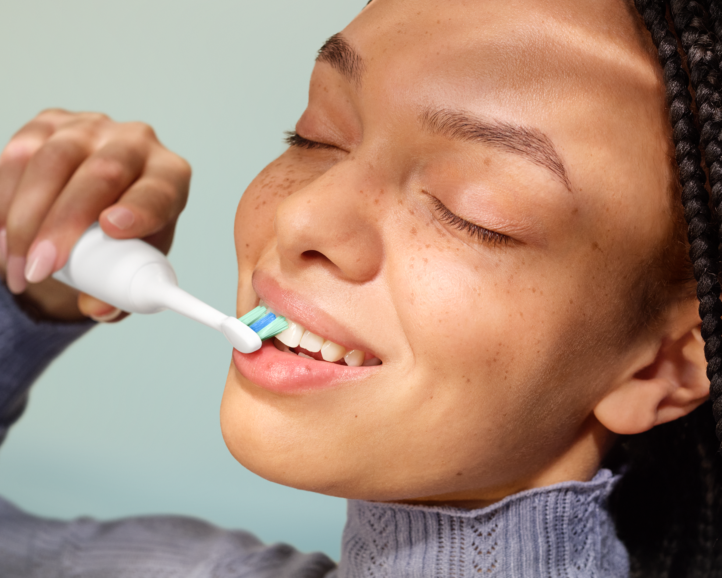 A patient brushing with the power toothbrush.