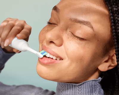 A patient brushing with the power toothbrush.