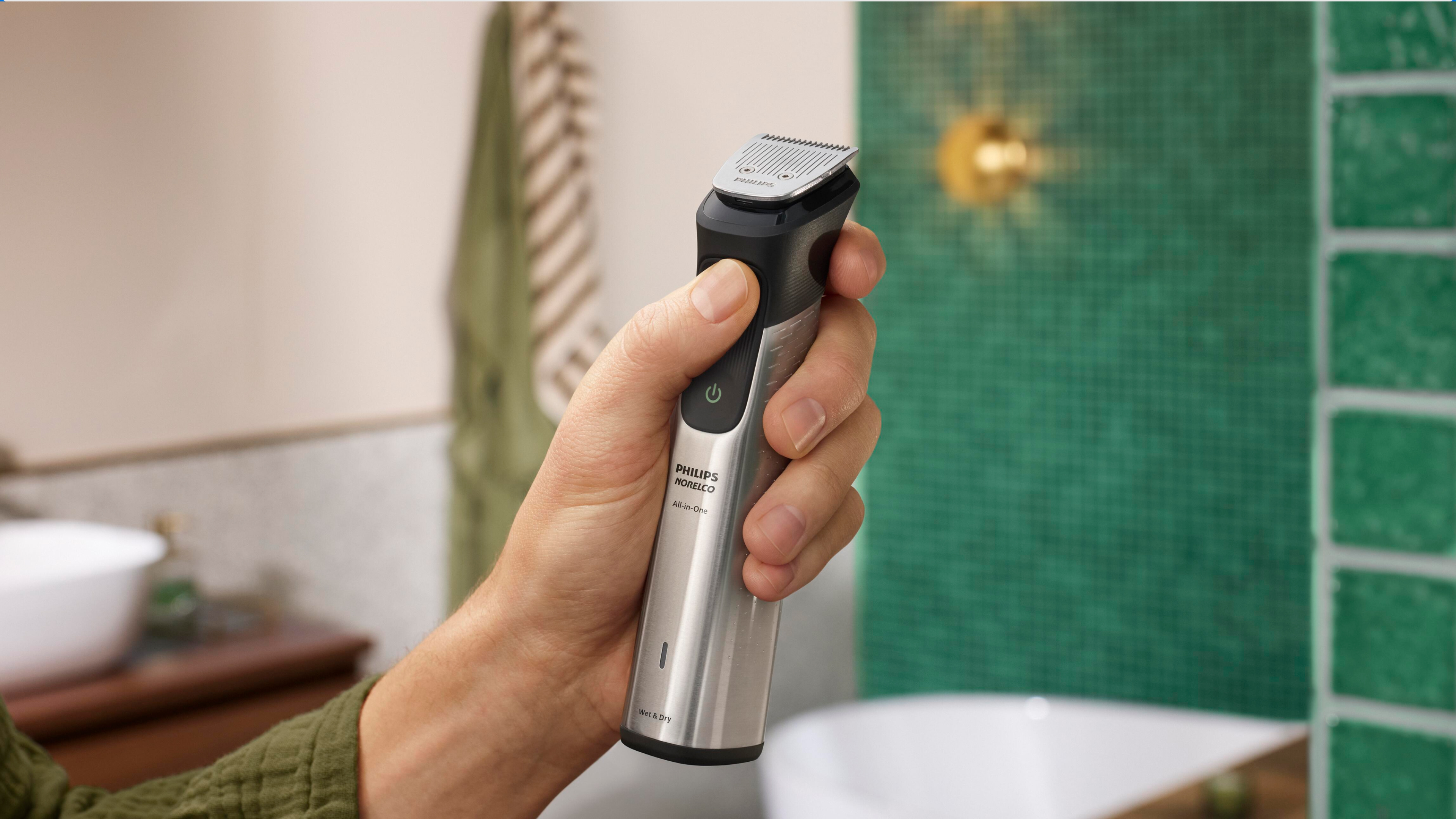 Hand holding Philips Norelco All-in-One Trimmer 9000