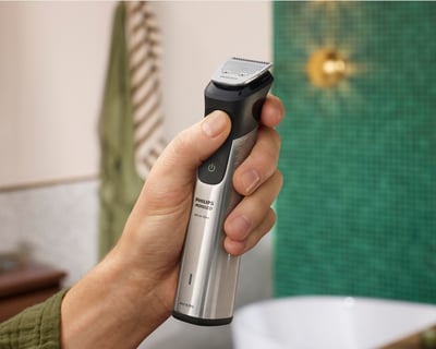 Hand holding Philips Norelco All-in-One Trimmer 9000